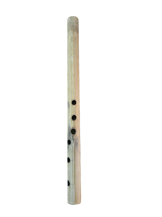 Wooden flute on a dark, scratched surface