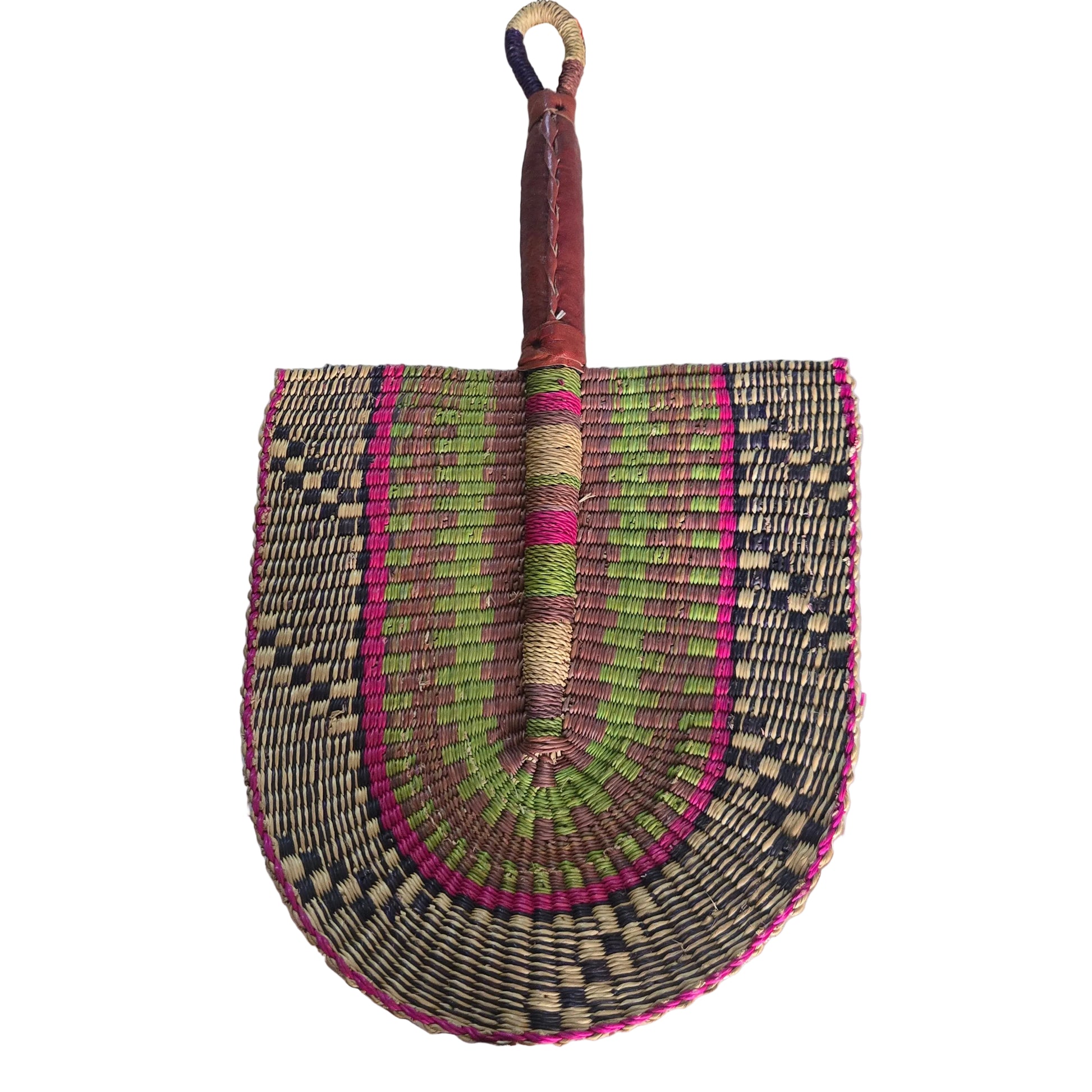 A hand-woven palm fan with a brown leather handle and a multicolored woven blade, resting on a white plastic tub in an indoor setting.