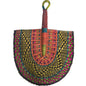 A hand-woven semicircular fan with a brown wooden handle and a colorful woven head, placed on a white plastic tub.