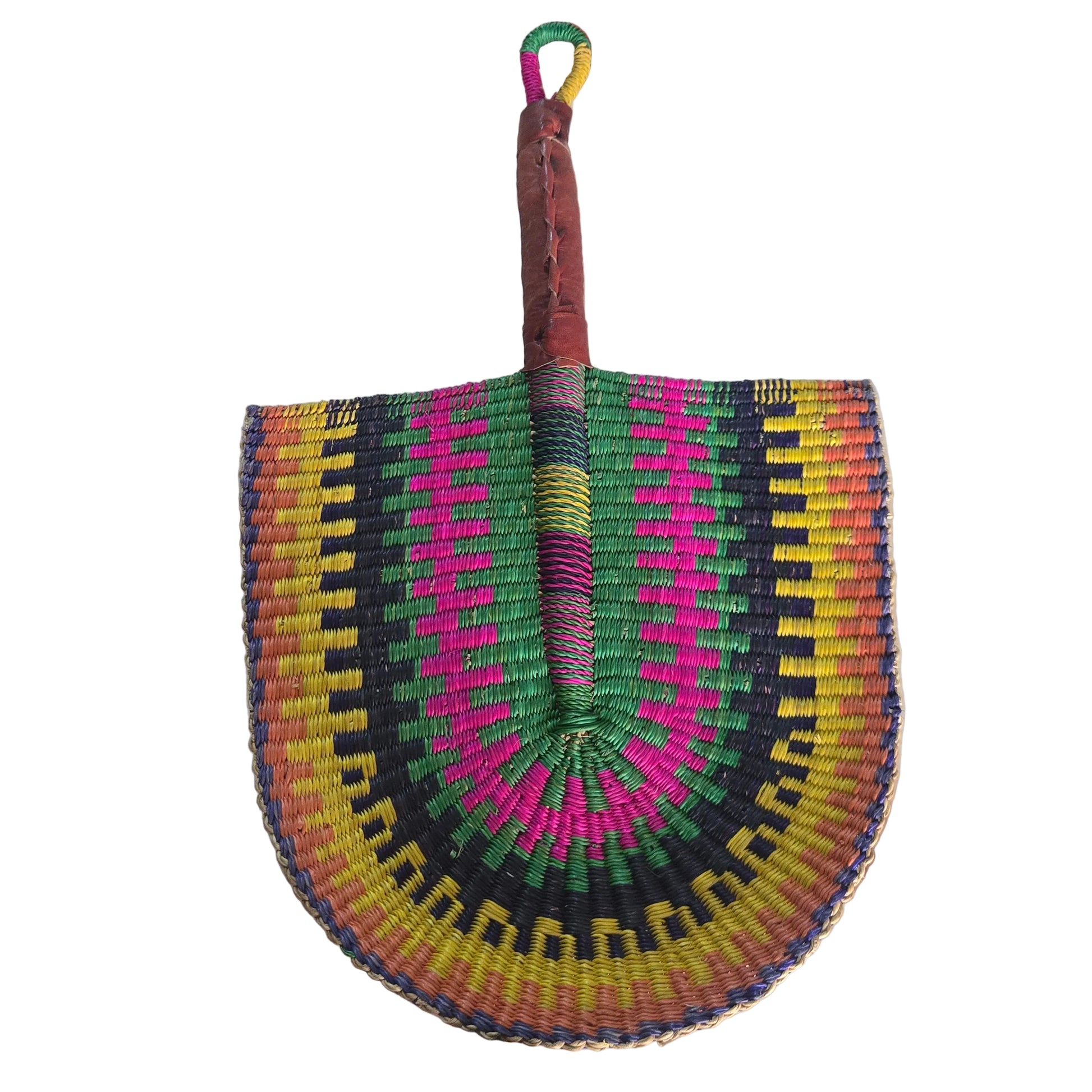 A colorful hand-woven fan with a geometric pattern in pink, green, yellow, and black, resting on a white plastic tub.