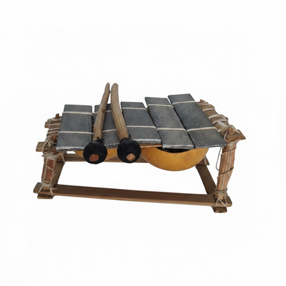 A miniature toy or model of a small vehicle with a gray and black checkered canopy, wooden wheels, and a yellow undercarriage, 